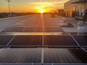 Sunset over rooftop solar panels apartment building Washington DC commercial solar