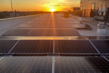 Sunset over rooftop solar panels apartment building Washington DC commercial solar
