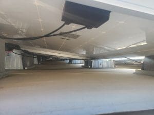 Underneath a rooftop solar array installed by Aurora Energy