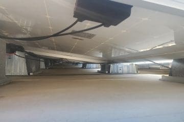 Underneath a rooftop solar array installed by Aurora Energy