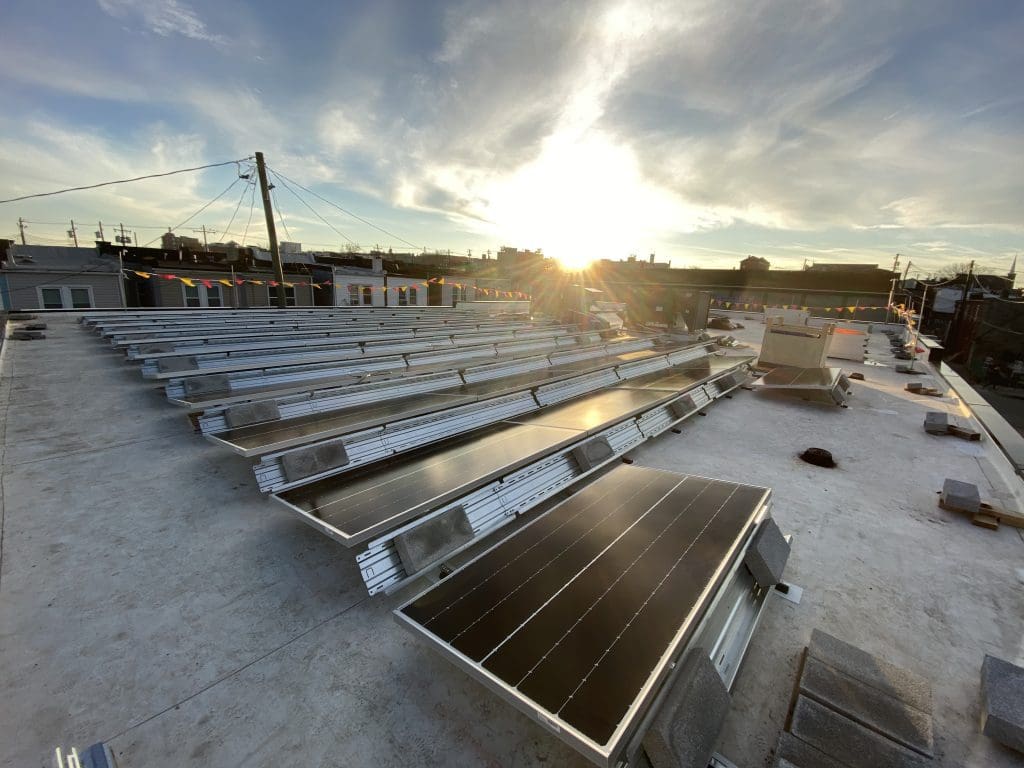 Sun setting on a solar array on a commercial rooftop in Baltimore MD