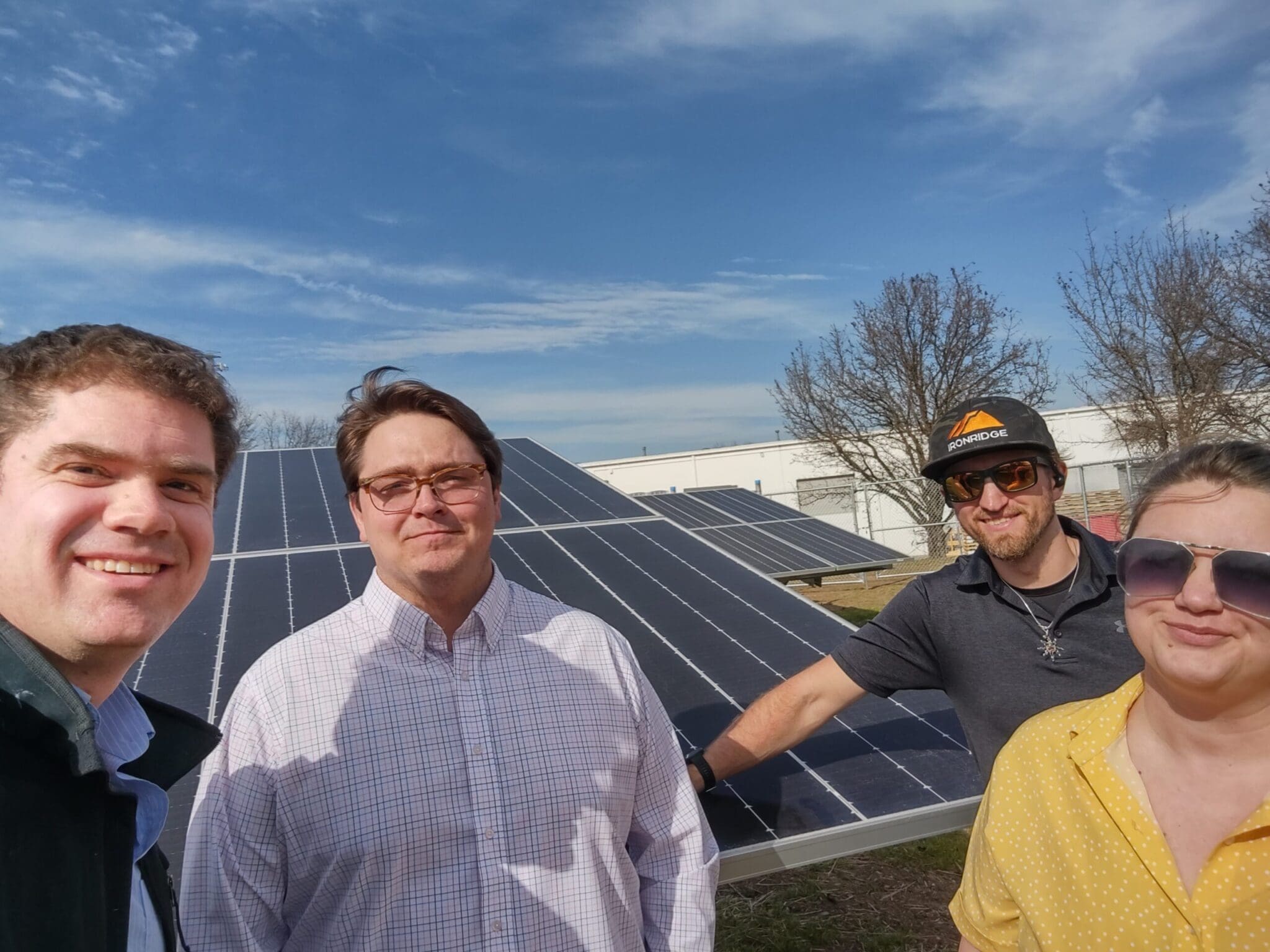 Simon, Justin, Cord, Jodi handing at a solar farm